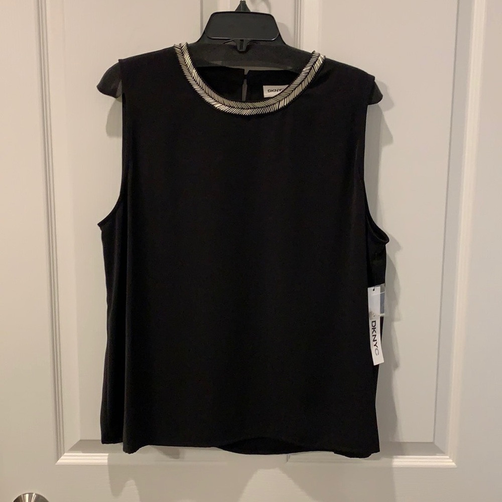 Sleeveless blouse with silver embellishments.